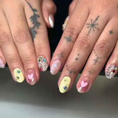 a mismatched manicure with gemstones, builder gel accents, and nail art