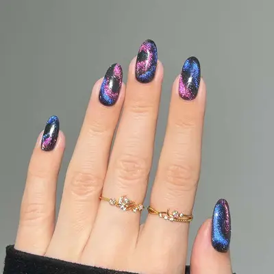 cosmic velvet manicure in purple, pink, and black