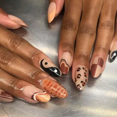 a mismatched manicure with a leopard print finger