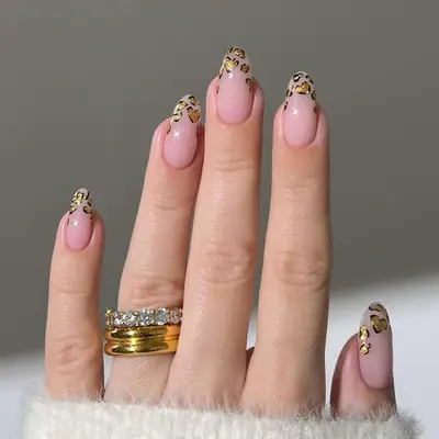 A milky manicure with heart shaped leopard tips