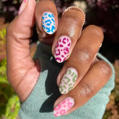 a negative space leopard print mani with a milky base