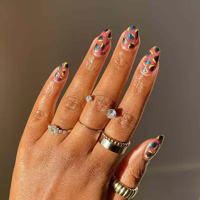an animal print manicure with neon and blue-black polish