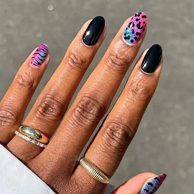 a lisa frank-inspired manicure with black accent nails