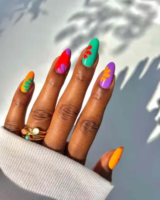 a colorful manicure with floral slice accents