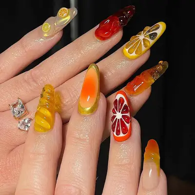 tropical fruit manicure with yellows, oranges, and reds