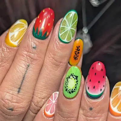 Decorated fingernails with fruit-themed designs