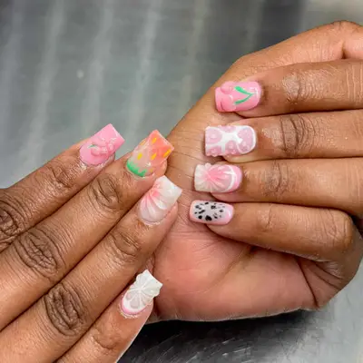 Hands displaying detailed nail art with various designs