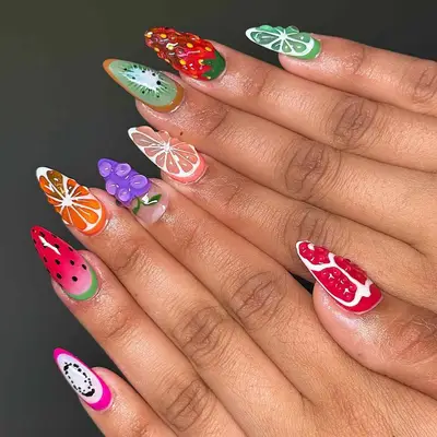 Stylized nail art with fruit themes on both hands