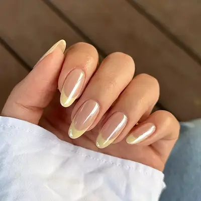 a yellow chrome french manicure