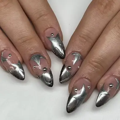 Close up of silver French manciure with faded silver stars.