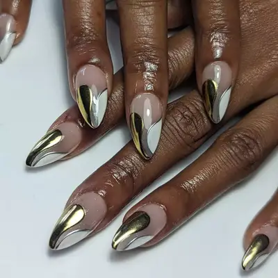 Close up of gold and silver mixed metal French manicure.