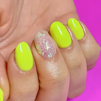 yellow neon nails with glitter flakes accent nail