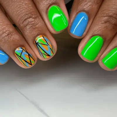neon green and blue nails with abstract line art accent nails
