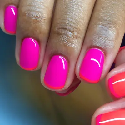neon pink nails with fuschia trim at the tips