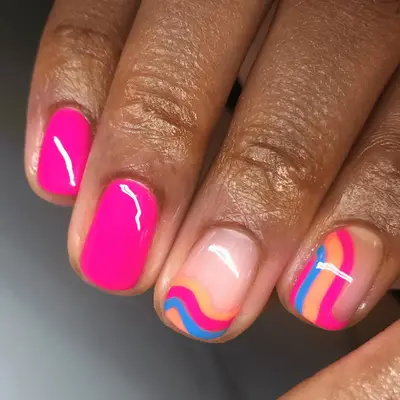 neon pink nails and neon pink blue and orange swirl accent nails