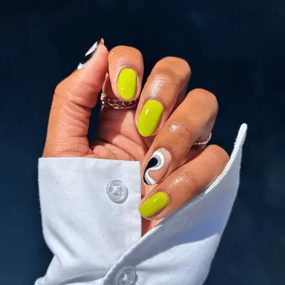 neon green nails and black white and gray squiggle accent nails