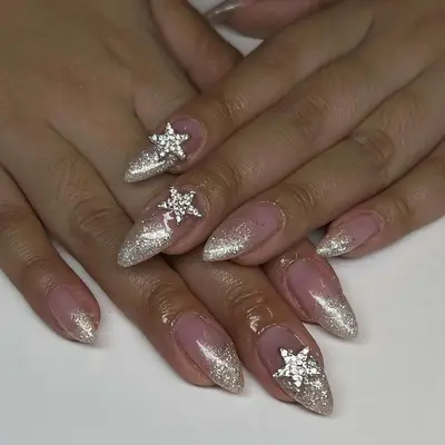 champagne glitter ombré nails with star charms