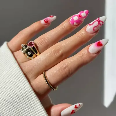 White long nails with mismatched hot pink designs on top