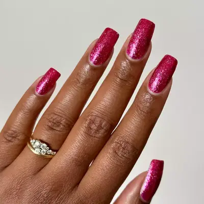 Long square nails with hot pink glitter polish