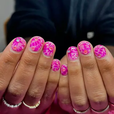 Short nails with hot pink design and 3D dew drops
