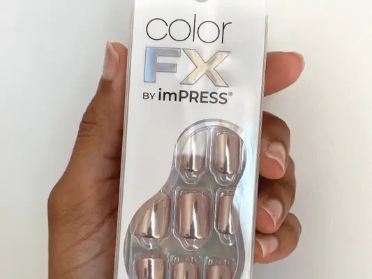 Hand holding the KISS imPRESS Color FX Press-On Nails in Wanderlust