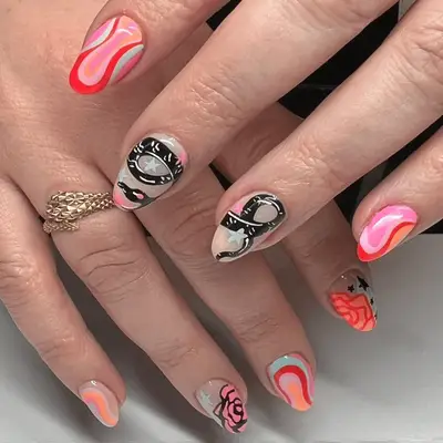 Pink and orange mismatched neon nails with a black snake nail art.