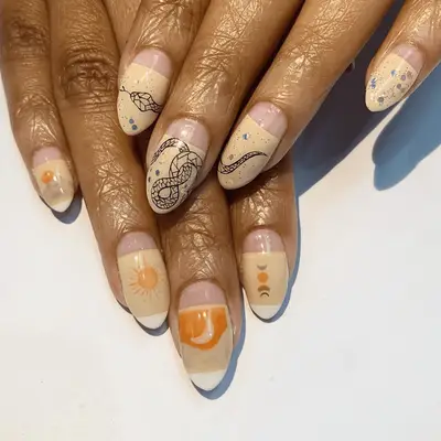 Yellow nails with sun and snake nail art.