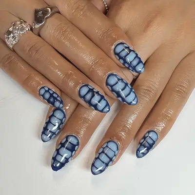 Blue snake print nails.