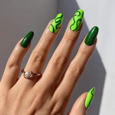 Neon green nails with sparkly evergreen squiggle art.
