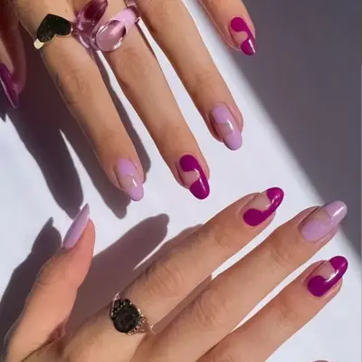 Negative space nail art design in lilac and orchid.
