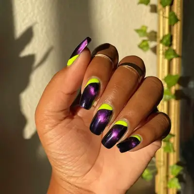Dark purple manicure with neon yellow stripe across the cuticle.