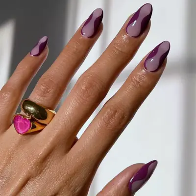 Purple curvy nail design with negative space.