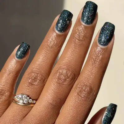 glittery teal manicure on short nails