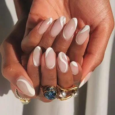 White almond nail art with neutral base