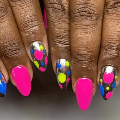 Silver chrome nails with multicolored polka dots and hot pink accent nails