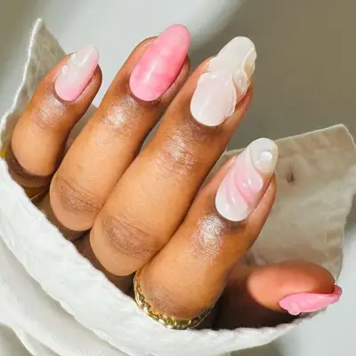 Pink and white almond-shaped manicure with 3D dewdrop designs