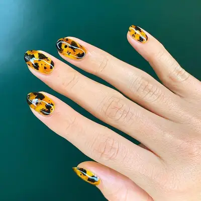 Orange and black tortoiseshell nail design