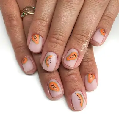 Papaya green, orange, and black nail design on translucent neutral manicure