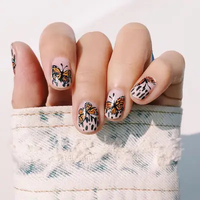 Manicure with orange and black monarch butterfly nail design