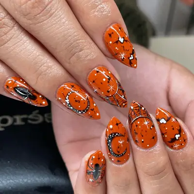 Black manicure with orange sparkle accent nails