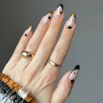 White, gray, orange, and black nail design with waves and speckles