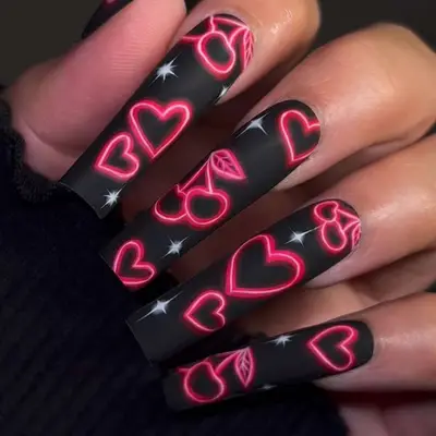 Black nails with neon pink cherry and heart designs