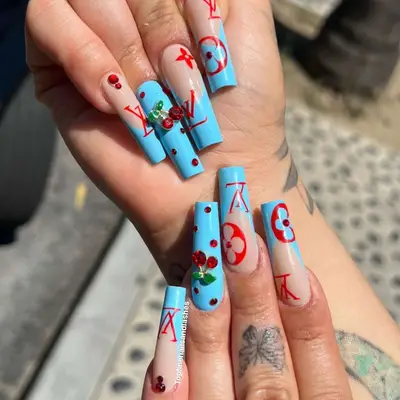 Blue French mani with LV logos and cherry accents