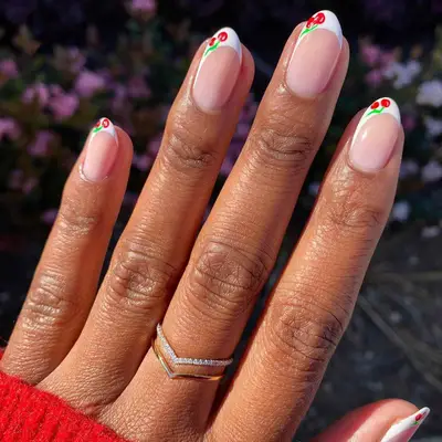 French manicure with asymmetric cherries at the tips