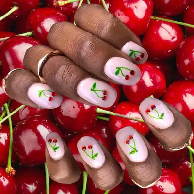 Pink manicure with cherry gemstones on each nail