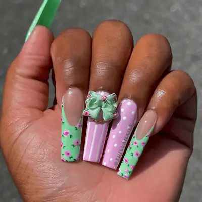 Pink polka dot and pastel green floral nails with 3D bow accent