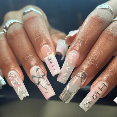 Long square nails with pink accents and silver 3D bows