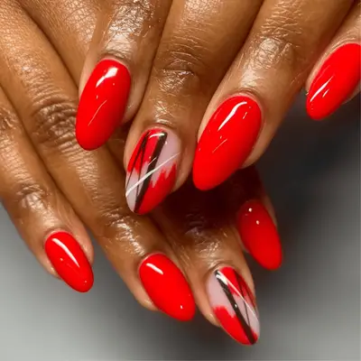 Red manicure with abstract nail art on one nail