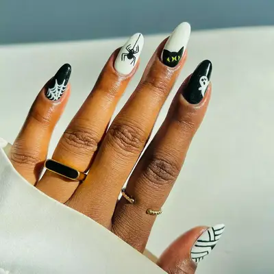 halloween nails with spider and spider web designs 