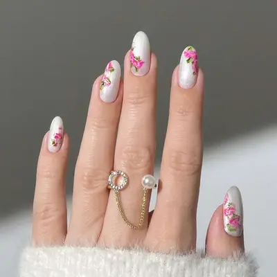 white chrome manicure with rose nail art